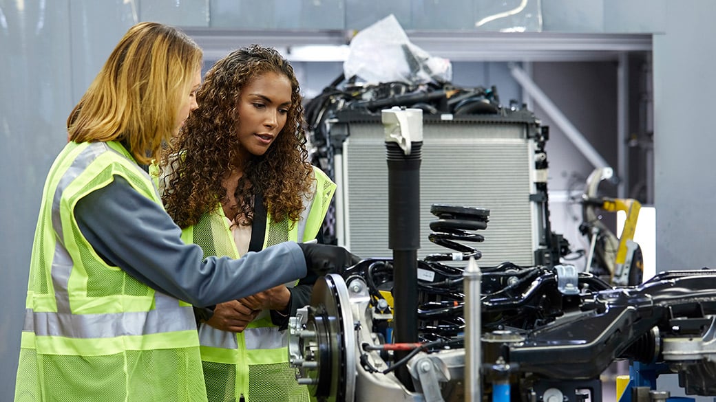 engineers-discussing-over-car-chassis.jpg